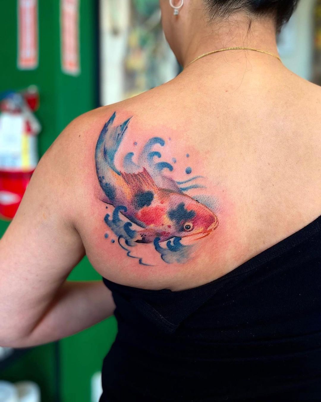 Vibrant Koi Fish Back Tattoo