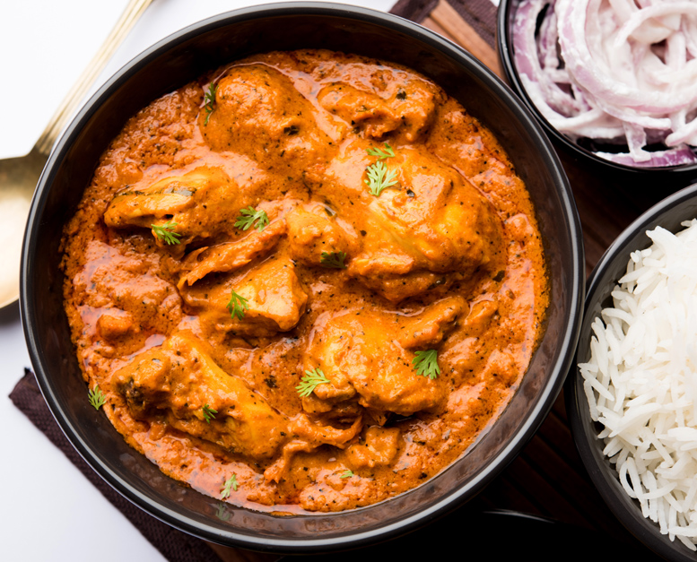 Murgh Makhani Or Butter Chicken Tikka Masala Served With Roti Or Paratha And Plain Rice Along With Onion Salad In Terracotta Crockery. Selective Focus