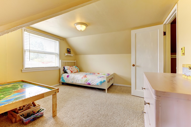 Yellow,vaulted,ceiling,room,with,carpet,floor.,furnished,with,wooden