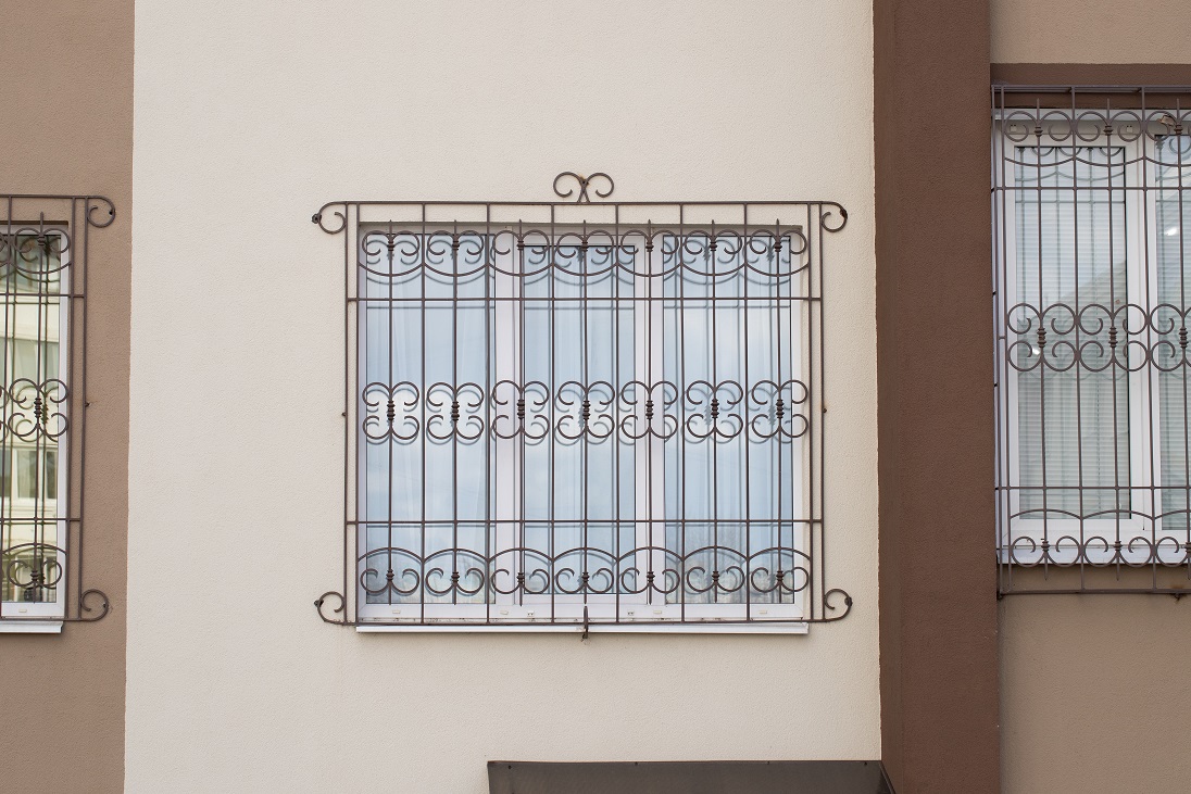 Iron,forged,lattice,on,window,house.