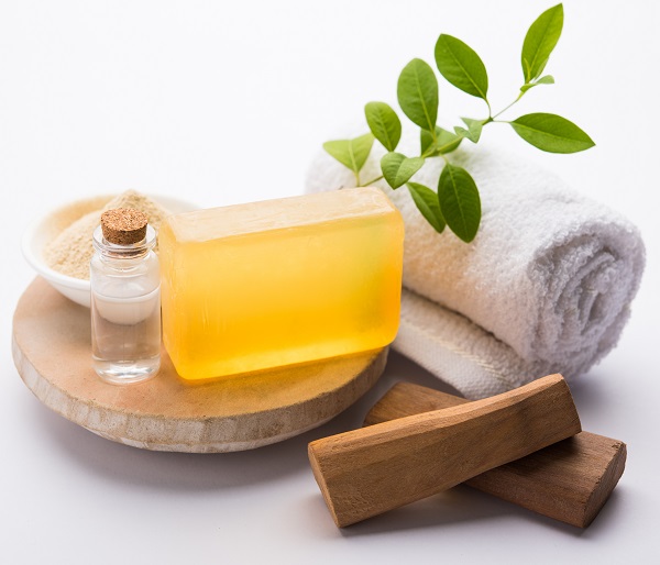 Sandalwood Or Chandan Handmade Bath Soap. Placed With Oil, Ubtan, Sticks And Towel, Selective Focus